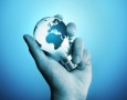 A man holding a bulb with the world on it.