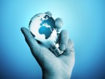 A man holding a bulb with the world on it.